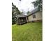 View of the home's rear screened in porch and an adjacent yard at 9160 Old Cascade Road Dr, Garner, NC 27529