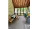 A screened porch with wood beams provides a relaxing outdoor space with views of the backyard at 9160 Old Cascade Road Dr, Garner, NC 27529