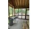 A screened porch with wood beams offers an outdoor relaxation space with backyard views at 9160 Old Cascade Road Dr, Garner, NC 27529