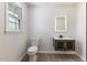 Bathroom featuring a vanity with an illuminated mirror, modern fixtures and wood-look flooring at 1020 Benning St, Durham, NC 27703