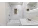Modern bathroom features sleek white tiling, a stylish vanity, and a shower over tub at 1020 Benning St, Durham, NC 27703