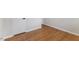 Hardwood flooring in bedroom leading to white door and corner of room at 1020 Benning St, Durham, NC 27703