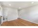 Bright bedroom with hardwood floors and two doors, one leading to a bathroom at 1020 Benning St, Durham, NC 27703