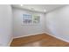 Bright bedroom with hardwood floors, recessed lighting, and double windows at 1020 Benning St, Durham, NC 27703