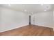 Bright, spacious bedroom featuring wood floors, a white door, and neutral wall paint at 1020 Benning St, Durham, NC 27703