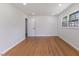 Spacious bedroom with wood floors, white walls, and a window offering natural light at 1020 Benning St, Durham, NC 27703