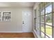Bright entryway featuring wood floors, white walls, and a multi-paned sidelight window at 1020 Benning St, Durham, NC 27703