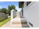 Brick patterned side porch and steps leading to a white brick home exterior at 1020 Benning St, Durham, NC 27703