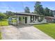 Well maintained exterior of a white home with a covered parking area and green lawn at 1020 Benning St, Durham, NC 27703
