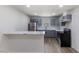 Modern kitchen featuring grey cabinets, stainless steel appliances and breakfast bar at 1020 Benning St, Durham, NC 27703