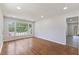 Open living room with hardwood floors, natural light, and neutral paint at 1020 Benning St, Durham, NC 27703