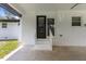View of the patio showcasing a step up to the back door and the exterior brick wall at 1020 Benning St, Durham, NC 27703