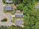An aerial view shows the home nestled amongst lush trees in a desirable neighborhood at 137 Cricketgrass Dr, Cary, NC 27513