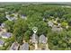 Aerial shot of a home nestled in a lush neighborhood with mature trees at 137 Cricketgrass Dr, Cary, NC 27513