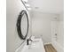 Bathroom featuring a unique mirror, a white countertop, and wood-look flooring at 137 Cricketgrass Dr, Cary, NC 27513