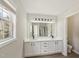 Bathroom featuring a double vanity with white countertops and modern fixtures at 137 Cricketgrass Dr, Cary, NC 27513
