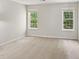 Carpeted bedroom featuring two large windows providing natural light at 137 Cricketgrass Dr, Cary, NC 27513