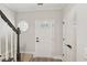 Inviting entryway with decorative front door and staircase featuring a dark wood banister at 137 Cricketgrass Dr, Cary, NC 27513