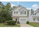Charming two-story home with white siding, a garage, manicured lawn, and tasteful landscaping at 137 Cricketgrass Dr, Cary, NC 27513