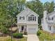 Two-story home with white siding, attached garage, manicured lawn, and front yard landscaping at 137 Cricketgrass Dr, Cary, NC 27513
