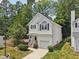 Aerial view of a two-story white home with a garage and well-manicured lawn at 137 Cricketgrass Dr, Cary, NC 27513