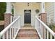 Inviting front porch with brick stairs and decorative railing to the front door at 137 Cricketgrass Dr, Cary, NC 27513