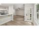 Open-concept space connects a kitchen with a bar and the living room with new flooring at 137 Cricketgrass Dr, Cary, NC 27513