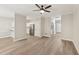 Spacious living room featuring hardwood floors, access to kitchen, laundry room, and staircase at 137 Cricketgrass Dr, Cary, NC 27513