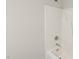 A close up of a shower/tub with white tile, silver fixtures, and a shower head at 137 Cricketgrass Dr, Cary, NC 27513