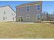 Spacious backyard with a lush green lawn and a modern gray two-story home at 138 Favored Avenue, Sanford, NC 27330