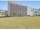 Expansive backyard with a well-maintained lawn, patio, and a gray two-story house at 138 Favored Avenue, Sanford, NC 27330