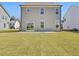 Expansive backyard with a well-maintained lawn, patio, and a gray two-story house at 138 Favored Avenue, Sanford, NC 27330