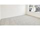 This bedroom has natural light through the large windows and soft neutral carpet, offering comfort at 138 Favored Avenue, Sanford, NC 27330