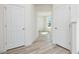 Bright hallway with luxury vinyl plank flooring leading to front door at 138 Favored Avenue, Sanford, NC 27330