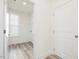 Well-lit laundry room with luxury vinyl plank flooring and shelving at 138 Favored Avenue, Sanford, NC 27330