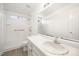 Bright bathroom with white cabinets, white walls and a large mirror over the vanity at 220 Needle Park Dr, Cary, NC 27513