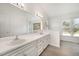 Bathroom with a double vanity, neutral colored walls and wood-look floors at 220 Needle Park Dr, Cary, NC 27513