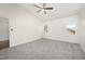Bright bedroom with vaulted ceiling, fan, neutral carpet and two windows at 220 Needle Park Dr, Cary, NC 27513