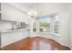 Cozy dining area featuring a bay window offering natural light, a chandelier, and wood floors at 220 Needle Park Dr, Cary, NC 27513