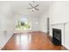 Open floor plan highlighting the fireplace, wood floors, bathroom access and bright natural light at 220 Needle Park Dr, Cary, NC 27513