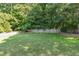 Large, serene backyard with a wooden fence, providing ample space for recreation and privacy at 321 Wescott Ridge Dr, Holly Springs, NC 27540