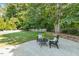 Inviting backyard featuring a stone patio and lush green grass, perfect for outdoor relaxation and entertaining at 321 Wescott Ridge Dr, Holly Springs, NC 27540