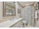 Cozy bathroom with granite countertop vanity, decorative shower curtain, and large, framed mirror at 321 Wescott Ridge Dr, Holly Springs, NC 27540