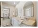 Bathroom with dual sinks, granite countertops, and framed mirrors, with hallway view at 321 Wescott Ridge Dr, Holly Springs, NC 27540