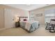 Cozy bedroom featuring a comfortable bed, rocking chair, and natural light from window at 321 Wescott Ridge Dr, Holly Springs, NC 27540