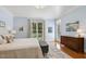 Bedroom featuring a large window, ensuite, and wooden dresser at 321 Wescott Ridge Dr, Holly Springs, NC 27540