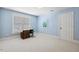 Bright bedroom features a window, a desk with a sewing machine, and light blue walls at 321 Wescott Ridge Dr, Holly Springs, NC 27540