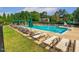 Community pool offers a refreshing retreat with plenty of lounge chairs for relaxation under shady umbrellas at 321 Wescott Ridge Dr, Holly Springs, NC 27540