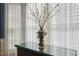 Dining room with a brass samovar, glass-topped sideboard, and sheer curtains at 321 Wescott Ridge Dr, Holly Springs, NC 27540