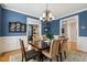 Formal dining room with dark wood furniture and trim, and a decorative plate rack at 321 Wescott Ridge Dr, Holly Springs, NC 27540
